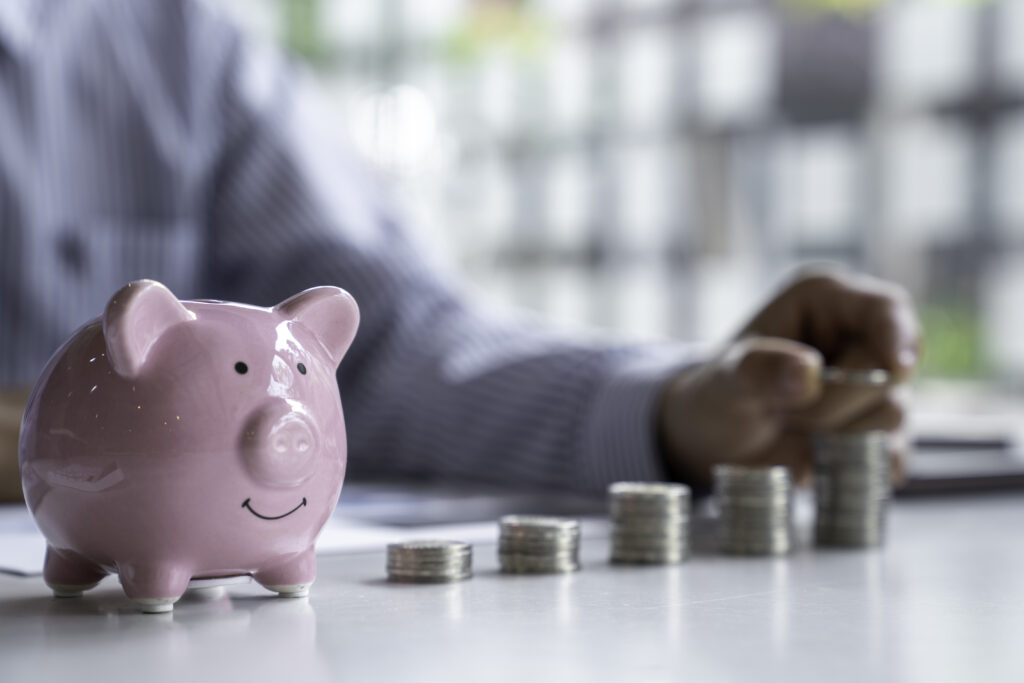 businessman-with-a-coin-in-a-piggy-bank-along-with-2025-02-18-05-13-26-utc